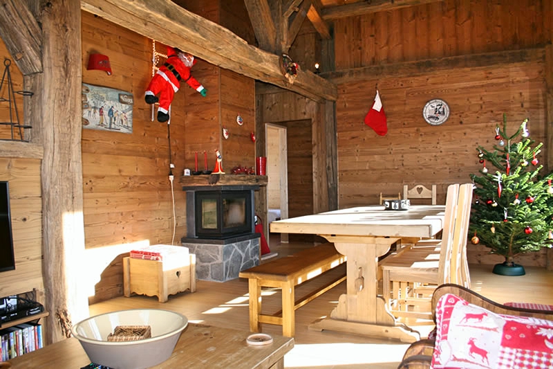 La salle à manger, sa table et sa cheminée vue depuis le salon